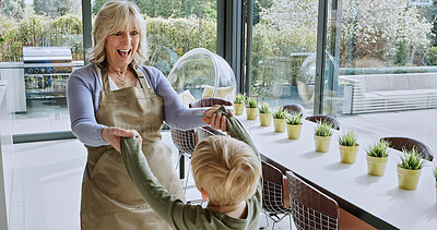 Buy stock photo Senior woman, child or playing in modern kitchen or happy bonding for relax wellness for family love. Grandmother, grandchild or cheerful on weekend for together or care in apartment in glass design