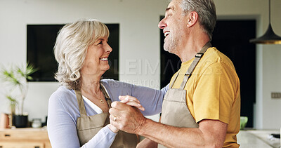 Buy stock photo Senior, couple and dancing in living room or happy with bonding, holding hands and marriage in house. Elderly, man and woman with dance for relationship, apron and romance with smile in apartment