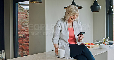 Buy stock photo Senior woman, drinking coffee and smartphone in kitchen or laugh, funny online conversation and social media. Happy person, cellphone and internet connection or mobile app for communication at home