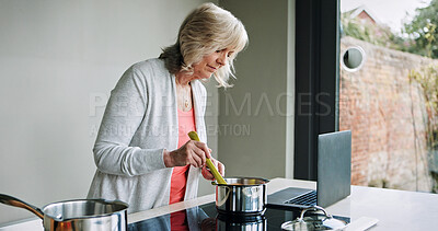 Buy stock photo Mature woman, cooking and laptop in kitchen with recipe or healthy food on stove for dinner. Vegetarian, diet and person in home learning to prepare mixture in pot with nutrition in lunch or meal