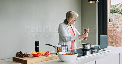 Buy stock photo Cooking, healthy food and mature woman in kitchen with laptop, recipe or reading a blog for dinner. Vegetarian, diet or person in home with vegetables, salad and nutrition in lunch or meal with salt