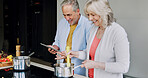 Elderly, couple and cooking in kitchen with tablet for meal prep, recipe idea and digital menu with happy. Senior, man and woman with technology at home for healthy food ingredients and diet planning