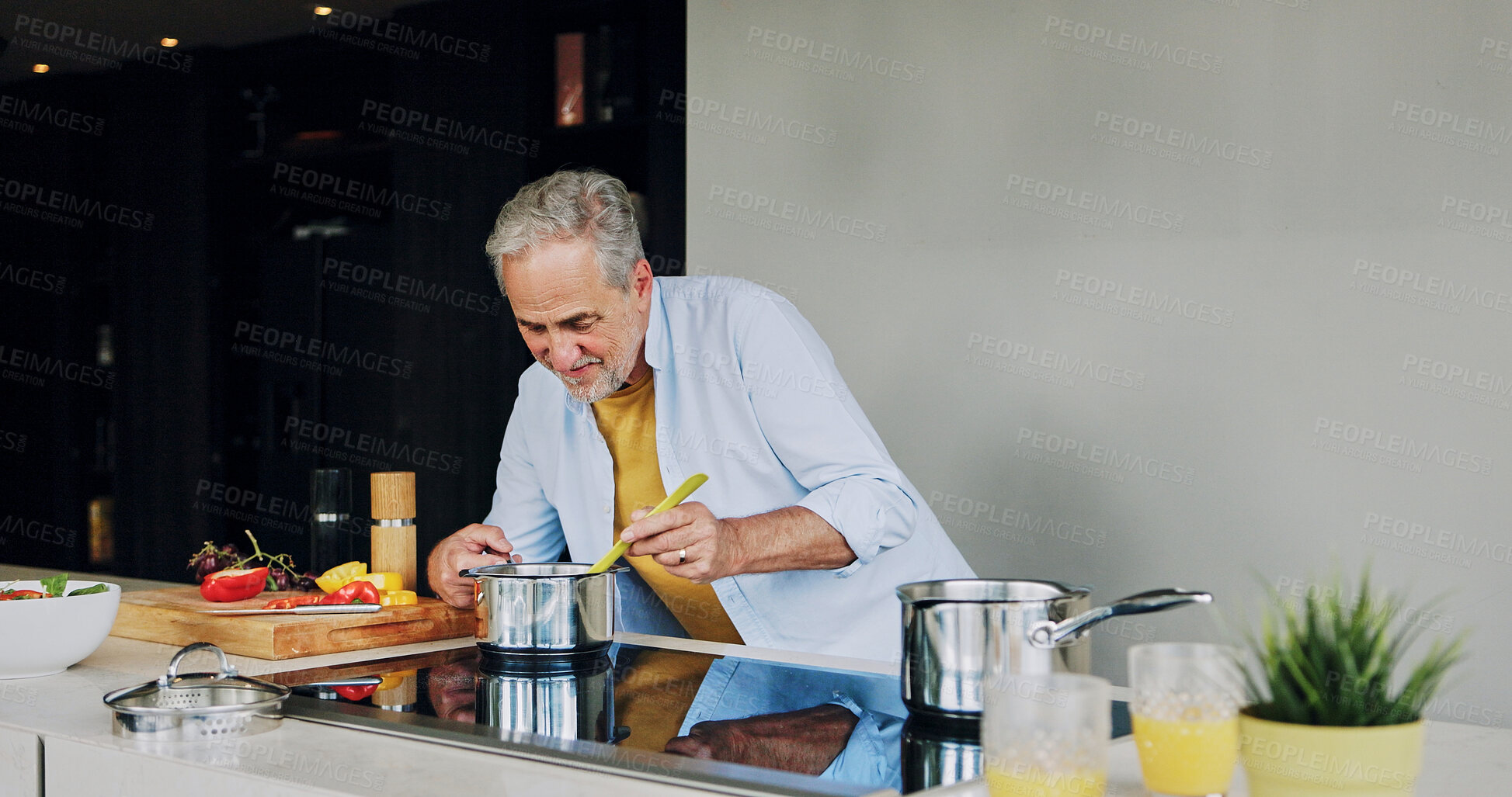 Buy stock photo Cooking, kitchen and senior man by stove for lunch, supper and prepare healthy dinner in home. Retirement, chef skills and mature person with natural ingredients, cutting vegetables and eating food