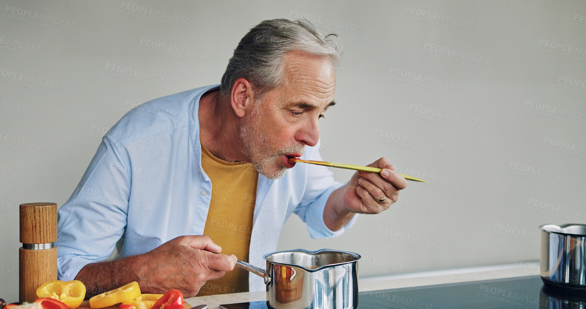 Buy stock photo Mature man, cooking and taste in kitchen with pot, spoon an vegetables for flavor, creativity and nutrition in home. Senior person, eating and test food with thinking, idea or recipe for diet in home