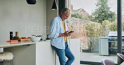 Buy stock photo Senior man in kitchen, relax with phone and morning breakfast, calm morning and checking social media. Home, online recipe and  elderly person with smartphone, smile and reading email on mobile app.