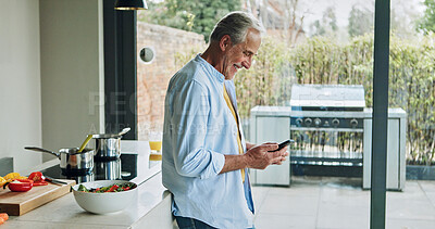 Buy stock photo Senior man in kitchen, smile with phone and cooking breakfast, calm morning and checking social media. Home, online recipe and  elderly person with smartphone, relax and reading email on mobile app.