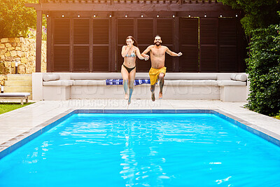 Buy stock photo Swimming pool, people and running outdoor for splash, travel and summer at luxury hotel as holiday. Water, couple and jump for wellness, hospitality and vacation at resort in Bali with freedom or fun