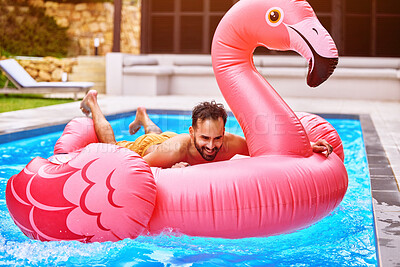 Buy stock photo Happiness, relax and man on inflatable in swimming pool for summer vacation, weekend break or getaway at resort. Outdoor, water and person on flamingo float for sunbathing, comfortable or holiday