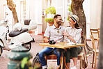 Happy couple, hug and travel with love at cafe on date, sightseeing or outdoor bonding together. Young man, woman or tourist enjoying romantic getaway, reservation or holiday trip outside coffee shop