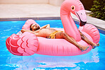 Water, relax and man on inflatable in swimming pool for summer vacation, weekend break or getaway at resort. Outdoor, safety and male person on flamingo float for sunbathing, comfortable or holiday