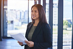 Professional, woman and reading paperwork in office for budget planning, finance portfolio and payment loan. Smile, female person and document for review, report and legal asset management of company