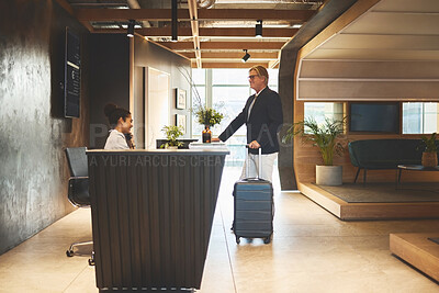 Buy stock photo Check in, reception and mature man with suitcase in hotel for business meeting, hospitality or travel. Service, concierge woman and person with luggage for welcome, vacation or sales convention