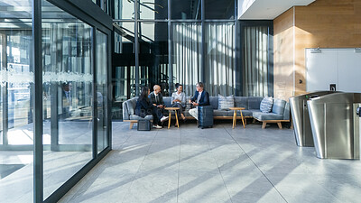 Buy stock photo Business people, airport lounge and luggage for travel in first class, international relations officer and meeting. Networking, adventure and group on couch, conversation and layover with suitcase