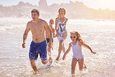 Buy stock photo Family, children and parents with running at beach, vacation and love with smile for summer in nature. Father, mother and kids with splash, holiday and excited for games in sunshine by ocean in Spain