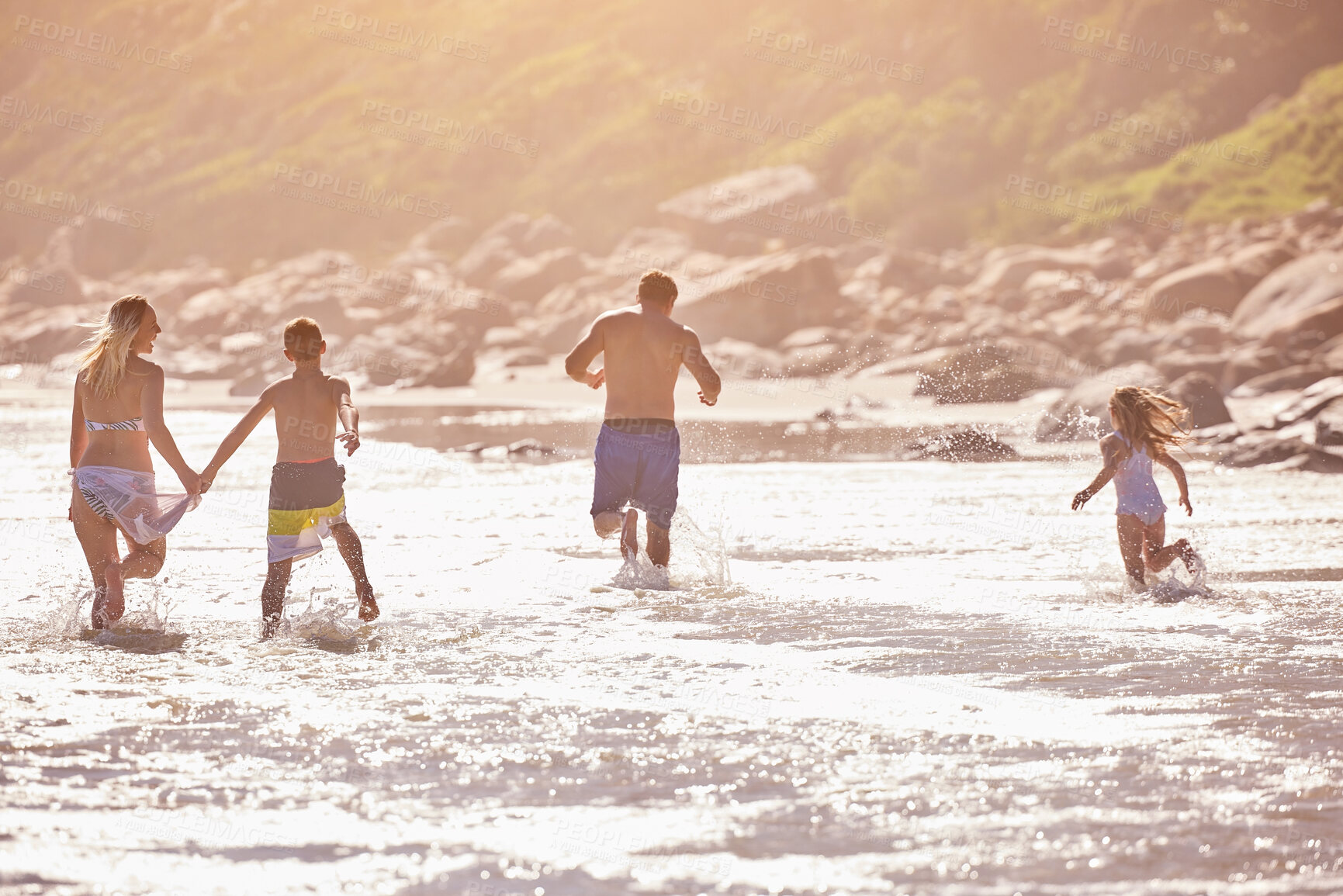 Buy stock photo Water, kids and parents running on beach for fun, travel holiday or bonding together on tropical adventure. Waves, energy and family playing on island vacation with ocean, splash and summer from back