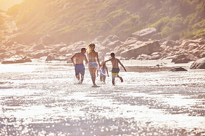 Buy stock photo Waves, children and parents running on beach for fun, travel holiday or bonding together on tropical adventure. Water, energy and family playing on island vacation with ocean, sea or summer from back