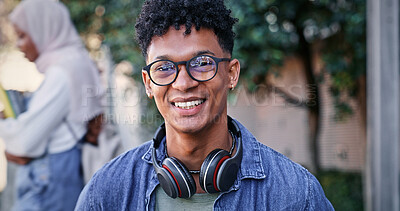 Buy stock photo Student, happy and portrait at university for education, glasses and pride for academic achievement. Man, smile and headphones on campus for knowledge, development and college scholarship opportunity
