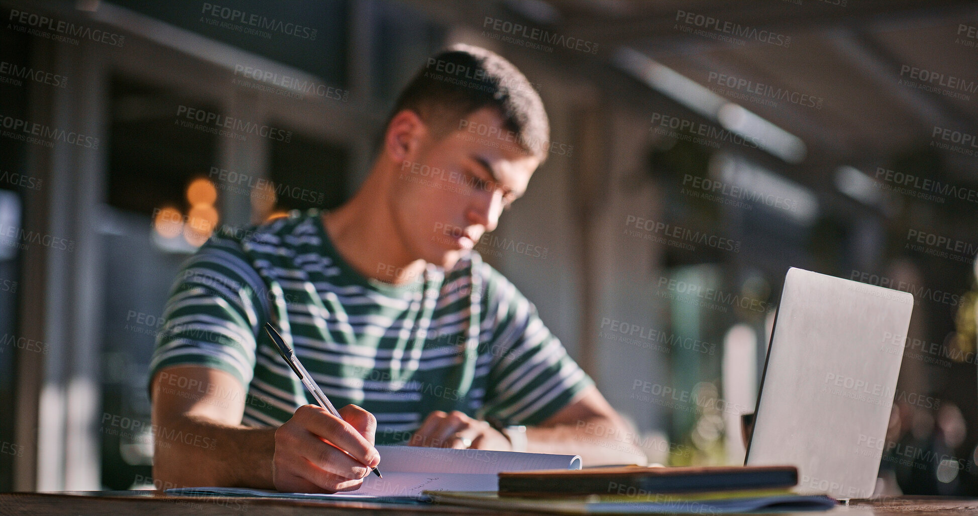 Buy stock photo Man, college student and outdoor with laptop or writing on notebook for assignment on campus. Male person, university learner and textbook for education with research or study for exam and assessment