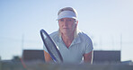 Fitness, tennis and mature woman with sportswear, racket and playing of game for exercise and active. Outdoor, healthy and person with equipment for workout, athlete and serious for sport and morning