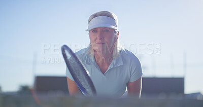 Buy stock photo Fitness, tennis and mature woman with sportswear, racket and playing of game for exercise and active. Outdoor, healthy and person with equipment for workout, athlete and serious for sport and morning