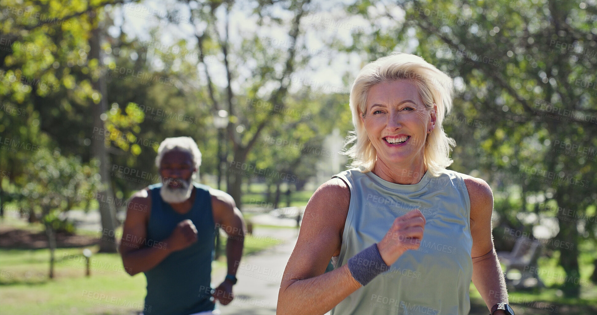 Buy stock photo Fitness, senior couple and running in park for wellness, cardio exercise and training in retirement. Interracial people, elderly and outdoor for workout with support, happiness or friends with energy