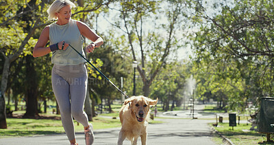 Buy stock photo Park, woman and happy for running with dog for fitness, exercise and workout in England. Mature person, outdoor and smile with jog as pet owner or animal with adoption, support and self care