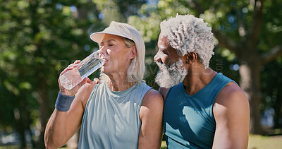 Buy stock photo Break, drinking water and fitness with mature couple in park together for exercise, running or training. Hug, hydration or rest with interracial man and woman outdoor for cardio, health or wellness