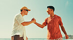 Happy, men and friends with handshake on beach of greeting, meeting and success of vacation. People, sunglasses and shaking hands for reunion agreement, introduction and thank you of tropical holiday