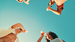 People, drinks and sky with friends, low angle and outdoor on vacation, break and event in summer. Men, women and bottle for soda with party, solidarity and nature with social group on holiday