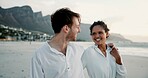 Smile, embrace and interracial couple at beach for love, care or holding hands for relationship. Ocean, happy man or woman outdoor for summer holiday, travel or romantic date with partner for support