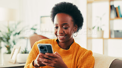 Buy stock photo Browsing, smile and woman with smartphone, relax and chatting with tech in living room or social media. Home, happy and black person with mobile for communication, internet and texting in lounge