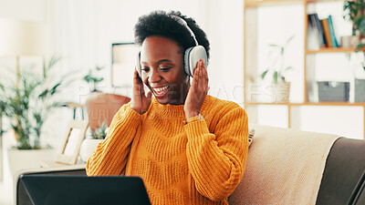 Buy stock photo Music, headphones and black woman with laptop on sofa with listen, happy and smile at home. Radio, earphones and African person with online, entertainment and podcast in living room for subscription