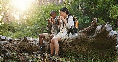 Buy stock photo Peace, coffee and hiking with interracial couple in nature for lunch break, trekking adventure and park conservation. Drinking, conversation and environment with man and women in forest for tea
