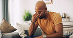 Home, fatigue and man with headache, stress and burnout with pain in living room. Person, apartment and guy on sofa with migraine, tired and exhausted with strain and sinus pressure from overwork