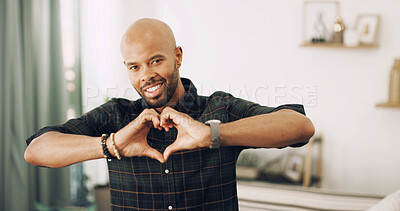 Buy stock photo Romance, portrait and man with heart hands, home or symbol for love in living room, smile or valentines day. House, happy or black person with sign for care, gesture or guy with finger shape in Kenya