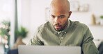 Remote work, laptop and man with review for networking, research and planning with news source. Freelancer, male journalist and reading with technology for article questions, information and home