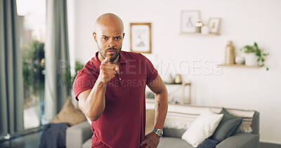 Buy stock photo Pointing, serious and portrait of man in home for discipline, blame or confrontation in living room. Angry, fighting and male person from Puerto Rico with finger for scolding with upset face in house