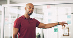 Presentation, talking and man with info, training and sticky notes in newsroom, meeting and pointing. Business, journalist and black person with plans for project, workshop and public speaking