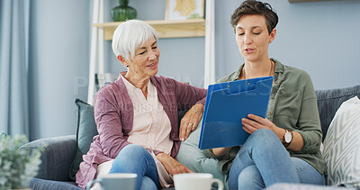 Buy stock photo Talking, senior woman and daughter with document, lounge or reading for benefits of health insurance. House, elderly mother and paperwork with info for coverage, people or explaining policy to parent