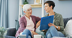 Home, senior woman and daughter with document, care and reading medical diagnosis in living room. Happy, elderly mother and paperwork with info for recovery, people and talking to parent in lounge