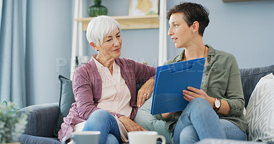 Buy stock photo Home, senior woman and daughter with document, care and explaining benefits of policy in living room. House, elderly mother and paperwork with info for health insurance, people and review of coverage
