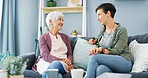 Conversation, relax and woman with senior mom on sofa with bonding, connection and family. Happy, talking and female person with elderly mother in living room at retirement home for catch up together