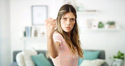 Buy stock photo Woman, angry and fist with portrait, threat or annoyed with fighting expression in living room. Conflict, argument and mad with crisis, worried and female person for issue disagreement in lounge