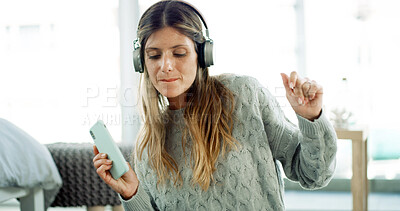 Buy stock photo Dancing, streaming and woman with headphones, home and smartphone with playlist on app and living room. House, fun and person with tech for music, listening and entertainment for girl with mobile