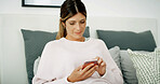Woman, texting and relax with phone on sofa, chat and check notification in living room at in home. Person, connection and scroll on smartphone, mobile app and contact on social network at apartment