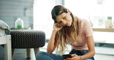 Buy stock photo Woman, phone and smile on floor with relax, social media and funny message in text. Female person, mobile and happy in home for meme website, comedy video and gossip conversation on contact app