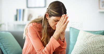 Buy stock photo Praying, sad and woman with stress, home and emotional for financial crisis in lounge and thinking. Mental health, overwhelmed and regret for quitting job, anxiety and person with faith in house