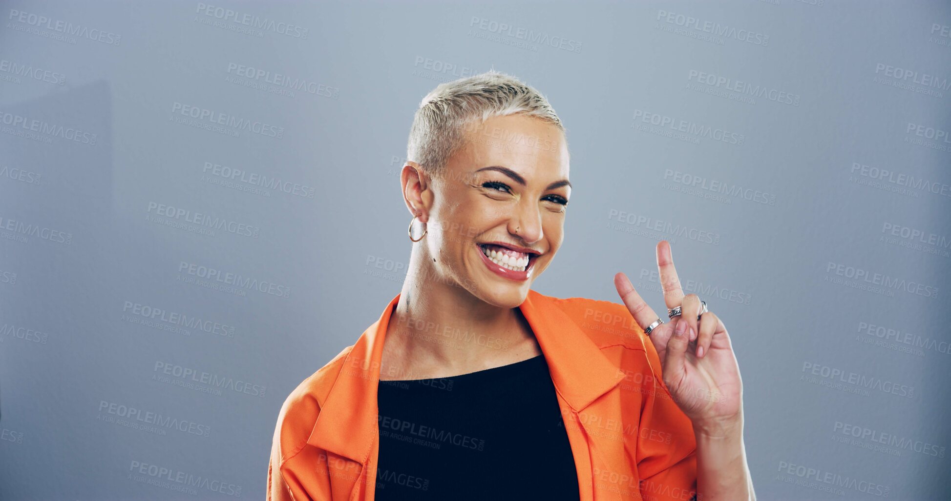 Buy stock photo Portrait, peace sign and woman with smile, icon and confidence on blue studio background. Face, happy person and model with hand gesture, support and agreement with symbol, good vibes and emoji