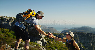 Buy stock photo Couple, hiking or helping hand with support on mountain for trekking journey or adventure in nature. Man, woman or hikers with smile, backpack or teamwork for aid, assistance or exploration together