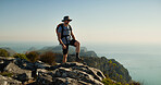 Hiking, travel and relax with man in nature for fitness, mountain adventure and workout. Space, rock and exercise with person outdoor view on cliff for trekking holiday, tourism explore and peace